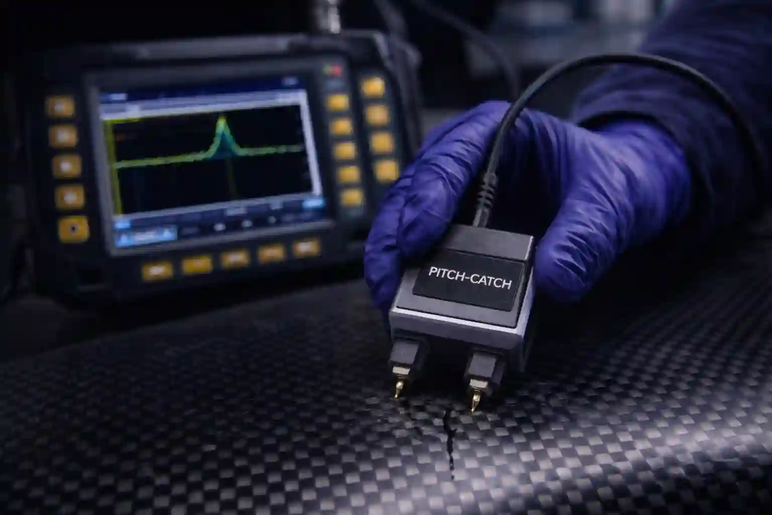 Technician performing composite inspection using ultrasonic bond tester